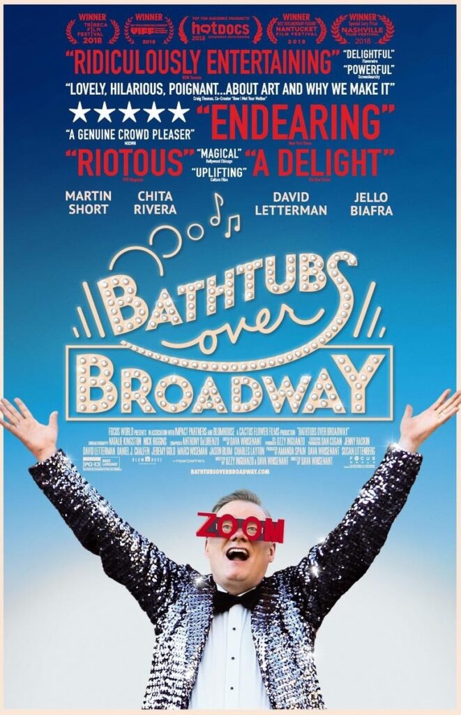 The poster for Bathtubs over Broadway: On the bottom Steve Young, wearing a white shirt, black fly and a very sparkling jacket as well as ZOOM-goggles (the letters), raising his arms above his head with a... probably exstatic expression? Over his arms the title, Bathtubs over Broadway, with faux lightbulbs painted in, and over that praise for the movie.