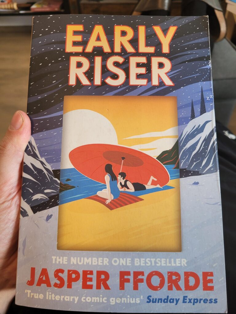 The cover of Early Riser, by Jasper Fforde It shows a stylized beach surrounded by cliffs in the deepest winter, in the middle of it a cut-out into a summer scene with a sunset and two people under a large umbrella.